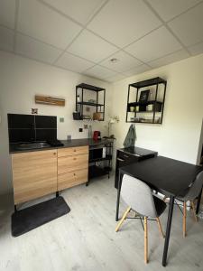 a room with a desk and a table and chairs at Peaceful apartment in Vierzon