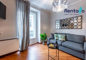 a living room with a couch and a window at Duomo Delight Suite - 200 meters from the Duomo in Milan