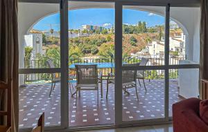 a view of a balcony with a table and chairs at 3 Bedroom Cozy Home In Fuengirola in Torremuelle +6 photos