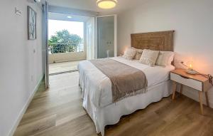 a bedroom with a large bed and a balcony at 1 Bedroom Lovely Apartment In Benalmadena in Torremuelle