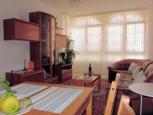 a living room with a couch and a table at Apartamentos Playa Monte Pindo - Morada Druida in O Pindo