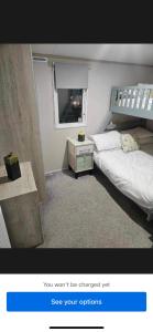 a picture of a bedroom with a bed and a window at Loch View 30 in Stranraer +20 photos