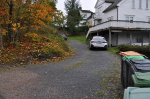 a car parked on a driveway in front of a house at FREDNES COSY RETREAT - One Bedroom Apartment in Porsgrunn