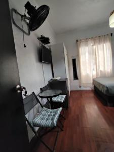 a room with a bed and a table and chairs at Casita Libertad Barranco in Lima