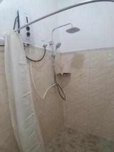 a shower in a bathroom with a shower curtain at White Room in Colombo Seven in Colombo +6 photos