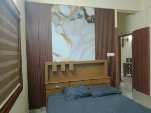 a bedroom with a bed with a painting on the wall at Haya homes in Vypīn