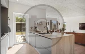 - une cuisine avec un évier et un miroir dans l'établissement 3 Bedroom Beautiful Home In Løkken, à Trudslev