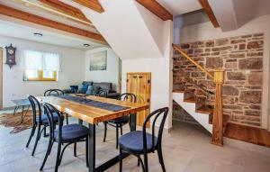 a dining room with a table and chairs at Nice Home In Murter With Private Swimming Pool, Can Be Inside Or Outside in Murter