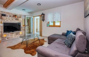 a living room with a couch and a table at Nice Home In Murter With Private Swimming Pool, Can Be Inside Or Outside in Murter