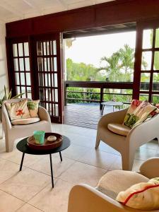 a living room with two couches and a table at Harbor View 4bd by ZenBreak in Saint Michael