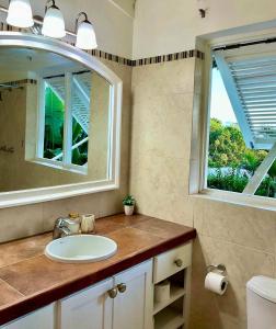 a bathroom with a sink and a mirror at Harbor View 4bd by ZenBreak in Saint Michael