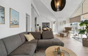a living room with a couch and a table at Cozy Home In Bogense With Sauna in Skåstrup