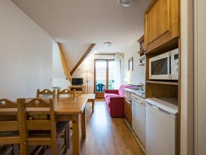 a kitchen and living room with a table and a dining room at Birdie E N23 - ST4 in Giez +3 photos