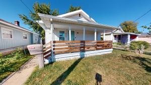a house with a wooden fence in the yard at 3 Bed 2 bath Pet Friendly in Historic Bates Hendricks in Indianapolis