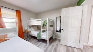 a bedroom with two bunk beds and an open door at 3 Bed 2 bath Pet Friendly in Historic Bates Hendricks in Indianapolis