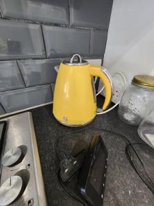 a yellow tea kettle sitting on top of a kitchen counter at The Walnut in Aveley