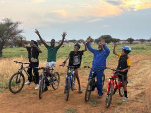 a group of people on bikes in a field at Shumba Camping Site 