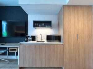 a kitchen with a sink and a microwave at NEW luxury suite Miami at the WorldCenter area - Great views in Miami