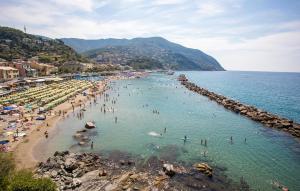 a group of people in the water at a beach at 1 Bedroom Awesome Apartment In San Saturnino in Bracco