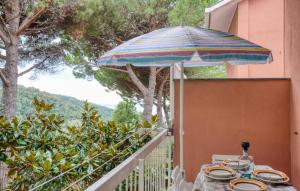 a table with an umbrella on a balcony at 1 Bedroom Awesome Apartment In San Saturnino in Bracco