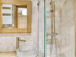 a bathroom with a shower with a sink and a mirror at Appartement 3 pièces avec balcon, cheminée et parking – À 400m des pistes et du golf, Megève Mont d'Arbois - FR-1-453-254 in Megève