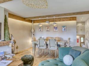 a living room with a table and chairs at Appartement 3 pièces avec balcon, cheminée et parking – À 400m des pistes et du golf, Megève Mont d'Arbois - FR-1-453-254 in Megève