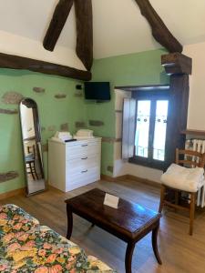a bedroom with a bed and a table and a mirror at Il Borgo di Monica - Appartamento 5 in Domodossola