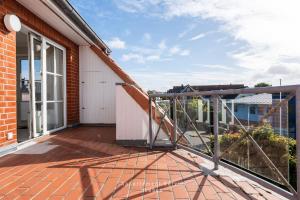 a balcony of a house with a glass door at Nautic W19 in Laboe