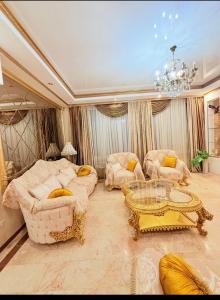 a living room with two couches and a chandelier at Квартира в центре Тбилиси in Tbilisi City +14 photos