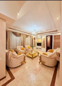 a large living room with couches and a table at Квартира в центре Тбилиси in Tbilisi City