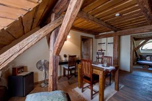 a dining room with a wooden table and chairs at Dvůr Olšiny -Hotel and Horse-riding in Karviná