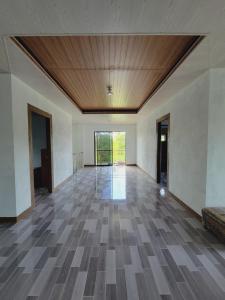 a large empty room with a wooden ceiling at Siargao Villaflor Residence in Dapa