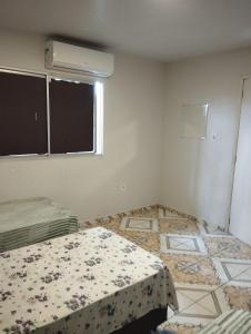 Postel nebo postele na pokoji v ubytování Residencial Humberto Mendes
