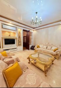 a living room with a couch and a coffee table at Квартира в центре Тбилиси in Tbilisi City