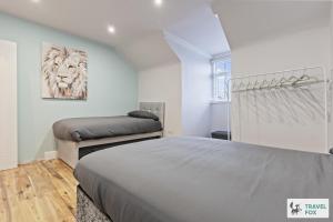 a bedroom with two beds and a lion picture on the wall at Bella's House 12mins bus to Motor Point Arena Free Street Parking in Nottingham