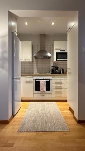 cocina con electrodomésticos blancos y alfombra en Viihtyisä kaksio keskustassa, en Kokkola