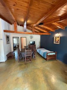 a bedroom with a bed and a table in a room at Complejo Sol Mediterraneo in Cosquín