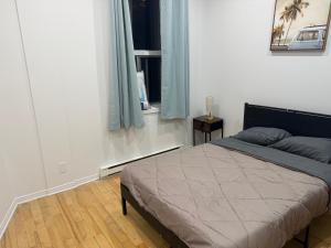 a bedroom with a bed and a window at Well located studio apartment with parking near downtown Montreal in Montréal