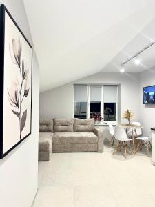 a living room with a couch and a table at City Apartments in Ivano-Frankivsʼk