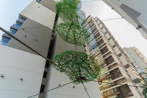 a sculpture of two umbrellas in front of a building at Roma Studio - Elegante & Aconchegante no Brooklin in Sao Paulo +24 photos