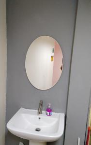 a bathroom with a sink and a mirror at RoXx Social Hostel in Bangkok