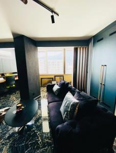 a living room with a couch and a table at Deluxe Maisonnette Skopje Center Ultra Modern Elegant Superb Sophisticated in Vodno