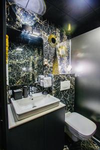 a bathroom with a sink and a toilet at Deluxe Maisonnette Skopje Center Ultra Modern Elegant Superb Sophisticated in Vodno