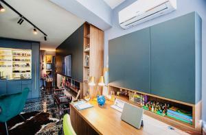 a home office with a desk with a laptop at Deluxe Maisonnette Skopje Center Ultra Modern Elegant Superb Sophisticated in Vodno +8 photos