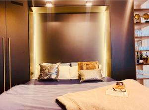a bedroom with a bed with a large headboard at Deluxe Maisonnette Skopje Center Ultra Modern Elegant Superb Sophisticated in Vodno