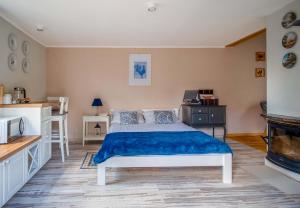 a bedroom with a bed with a blue blanket at Podlaski Zakątek in Bereżyszcze +112 photos