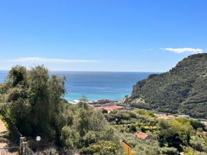a view of the ocean from a hill at Hostdomus - Phil House in Finale Ligure