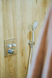 a shower with a blow dryer plugged into a wall at Bobble Mons in Mons +29 photos