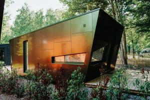 a small house is shown in a garden at Bobble Mons in Mons