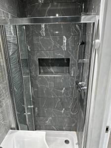 a bathroom with a shower and a sink at Comfort Rooms - East Croydon in South Norwood